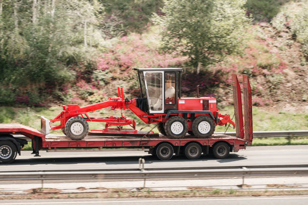 Truck carrying a grader machine