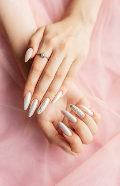 istock Female Hands with beautiful pearl manicure 2165975331
