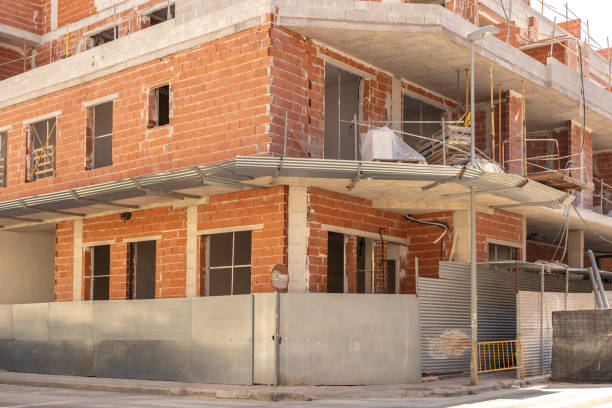 istock Dynamic process of urban development, showing a partially constructed building with visible brickwork. Ideal for articles on real estate development, urban planning, and construction. 2165979682