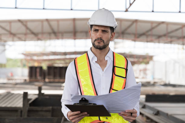 istock Male engineer construction working at construction site. Male engineer builder wear white helmet working at construction site 2165979791