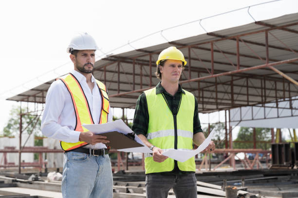 istock Team of male engineer construction working and inspecting structure of building at construction site. Two male construction builder working at construction site 2165979880