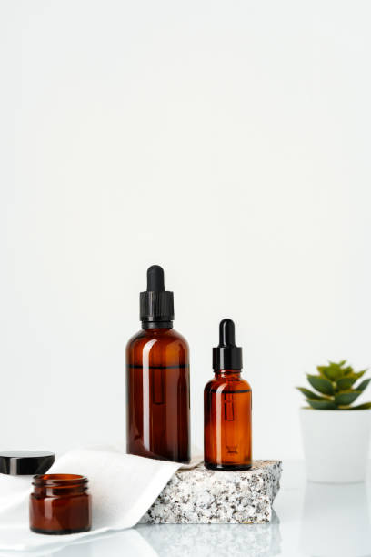 istock Amber Glass Bottles With Dropper Tops Displayed on a Stone Platform 2165980692