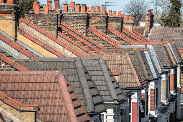 istock Brick chimneys and dormer rooftop in Victorian terraced houses 2165981995