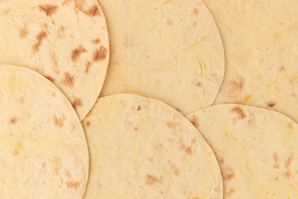 wheat round taco tortilla or pita lavash round flat bread from above, background of mexican tortilla