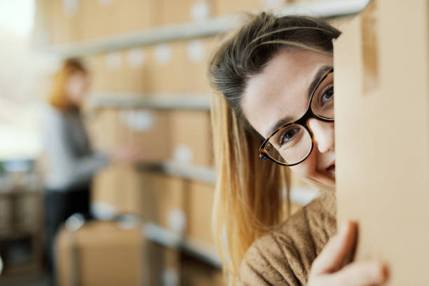 istock Happy e-commerce employee moving boxes in the warehouse 2165983982