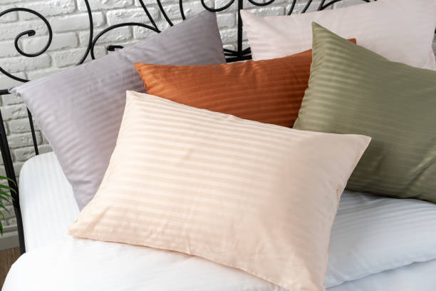 istock Striped Pillows on a Bed With Black Metal Headboard 2165984020