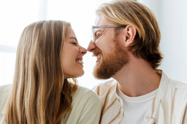 istock Cheerful couple touching noses and making funny faces 2165986726