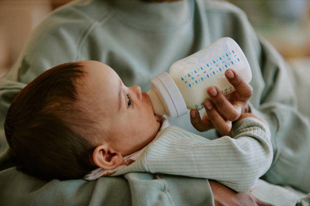 istock Baby Eating Formula in Mothers Hand 2165987480
