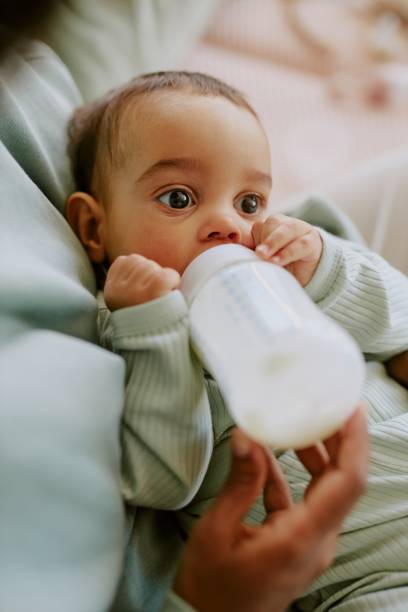 istock Baby Boy Drinking Formula in Mothers Arms 2165987485