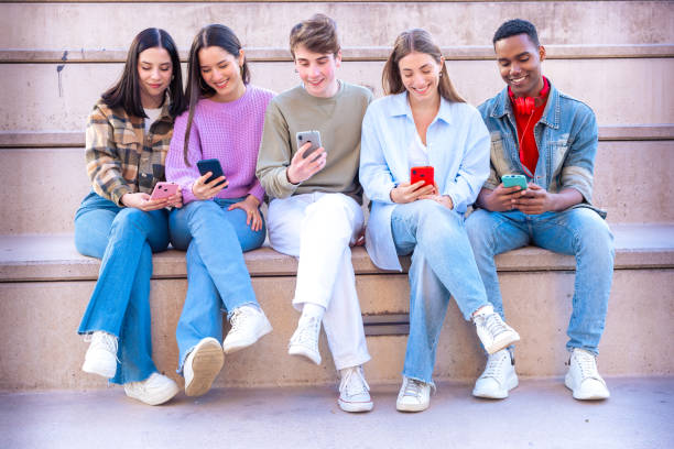 istock Five students having fun with mobile phones creating content on social media. 2165987724