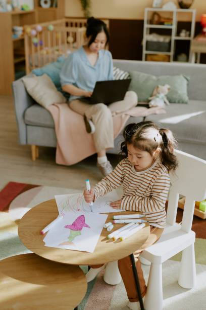 istock Girl Learning Drawing while Mother Busy 2165987933
