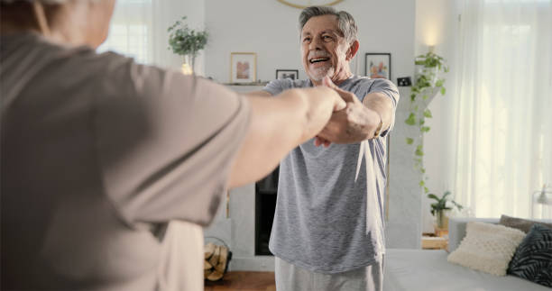 istock Senior couple exercising in living room 2166000455