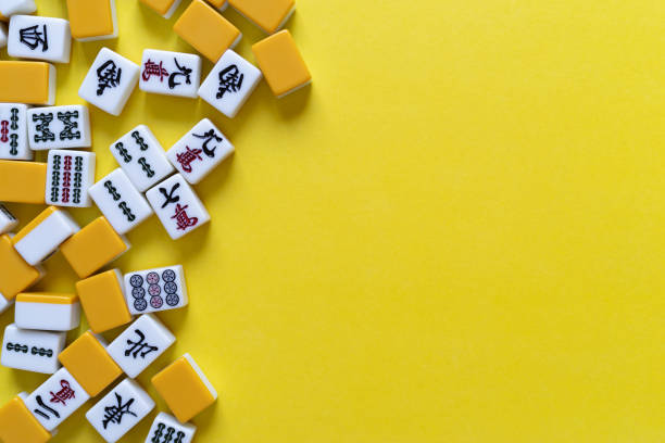 istock Mahjong tiles lined up on a yellow background 2166004162