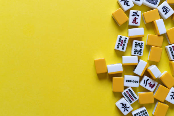 istock Mahjong tiles lined up on a yellow background 2166004199
