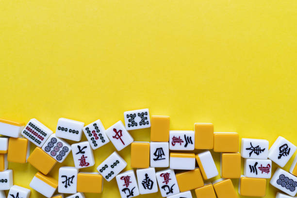 istock Mahjong tiles lined up on a yellow background 2166004217