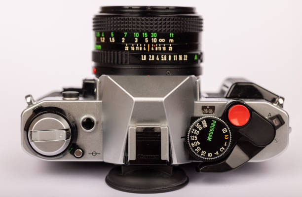 istock Close-up of a classic camera, featuring intricate controls, set against a plain white backdrop 2166004533
