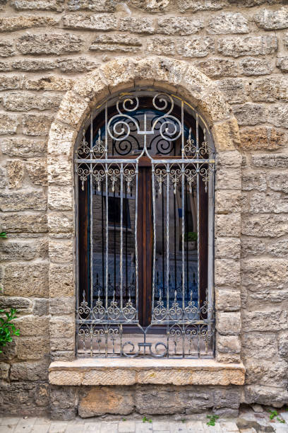 istock Decorative Iron Window With Stone Wall in Old Town at Dusk 2166005187