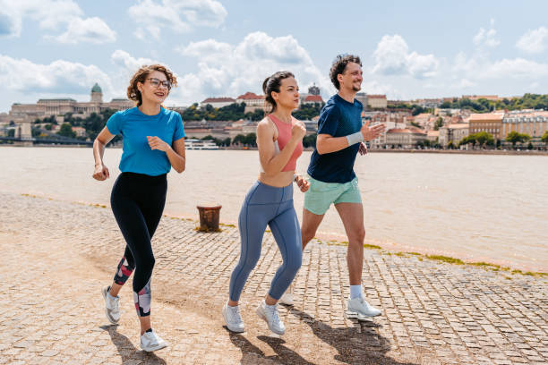 istock Three Friends Running On The Quayside In Budapest In Hungary 2166007521