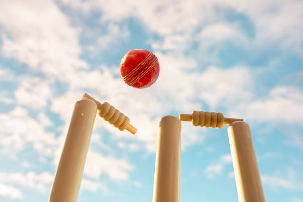 istock Cricket ball hitting wicket stumps and bails background 2166007684