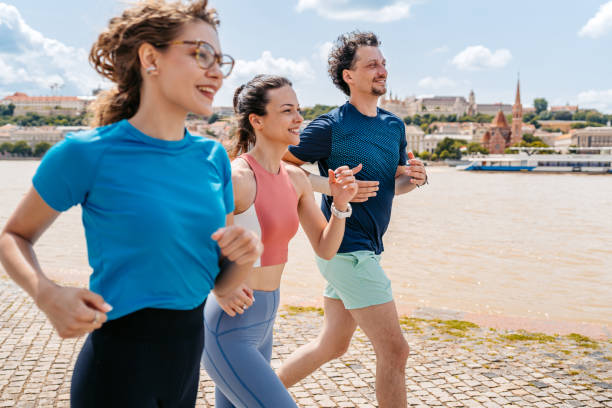 istock Three Friends Running On The Quayside In Budapest In Hungary 2166012128