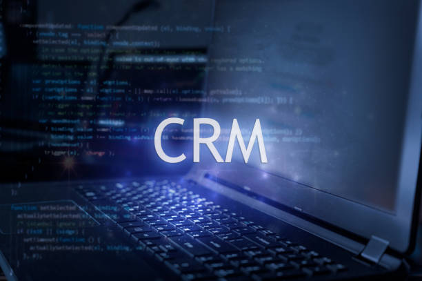 istock CRM inscription against laptop and code background. Customer relationship management  system. 2166014019