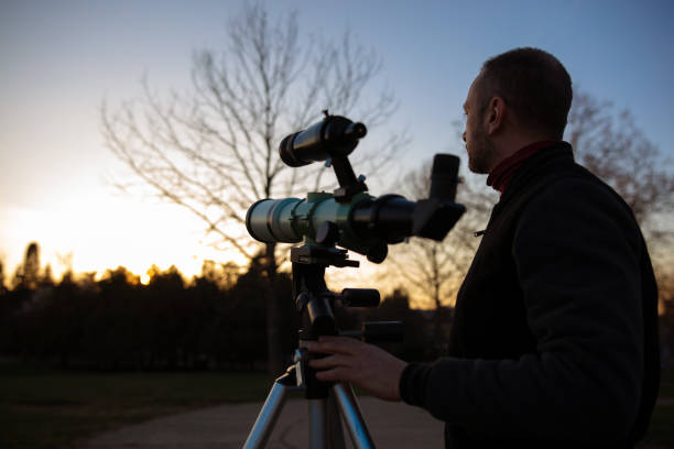 istock Amateur astronomer observing Sun eclipse and Sun with a telescope and special solar filter. 2166014031