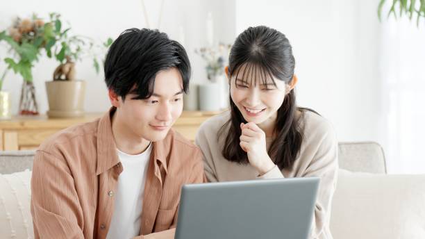 istock Couples browsing real estate and travel sites 2166015038