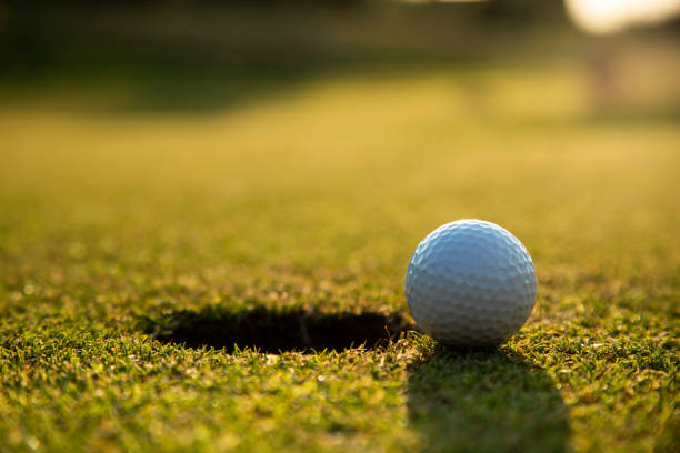 istock Closeup Golf ball on green grass on course 2166016344