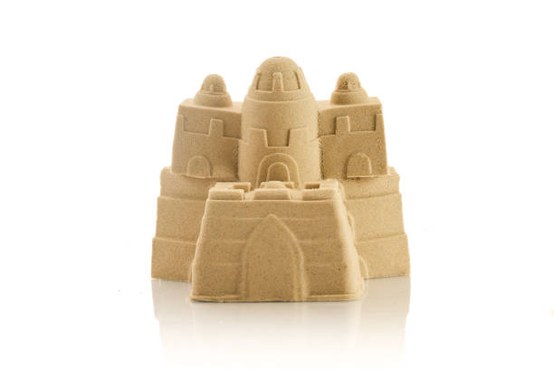istock A detailed sandcastle made from fine sand, isolated on a white background 2166017856