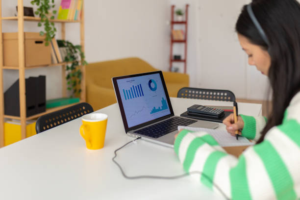 istock Asian young freelancer woman working on laptop computer at home 2166018493