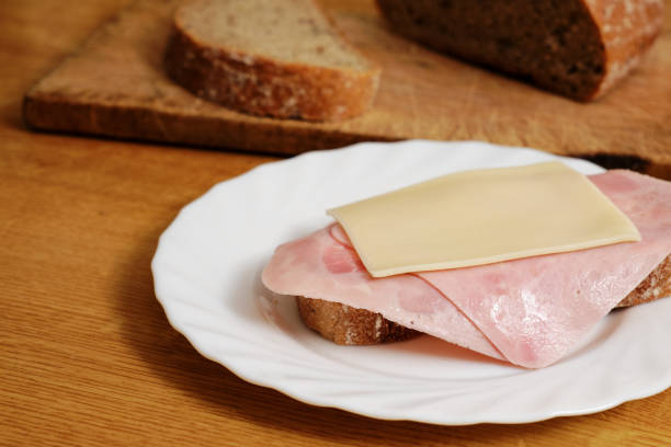 closeup honey ham wheat bread sandwich in white background