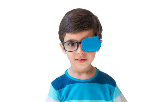 istock boy in glasses with eye patch. Occluder, lazyeye, amblyopia, strabismus. Vision testing concept. Reviewing eyesight 2166019925
