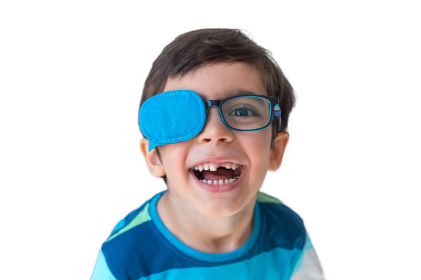 Portrait of boy in glasses with eye patch. Occluder, treat lazy eye, amblyopia, strabismus. Vision testing concept. Reviewing eyesight.