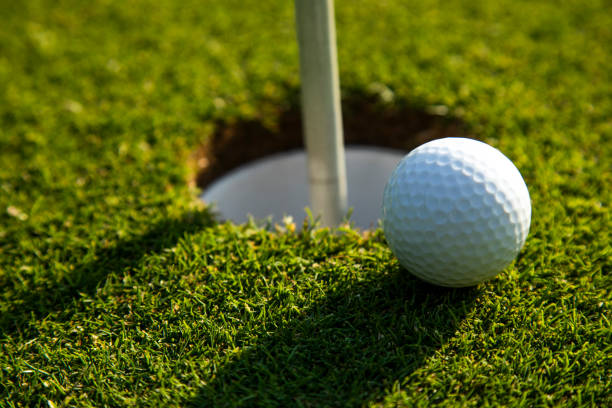 istock Closeup Golf ball on green grass on course 2166020459