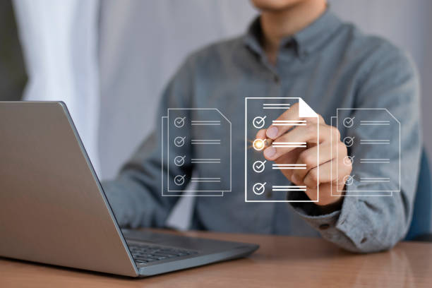 istock checklist Complete the performance review digital form checklist.business people using evaluation questionnaire evaluation 2166020654
