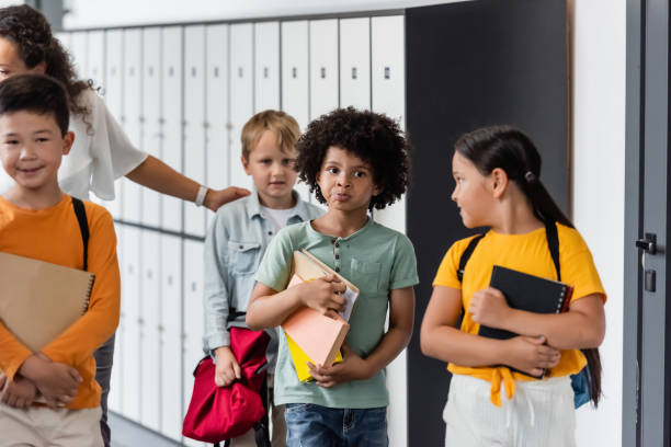 istock Multicultural school kids joyfully walk with their teacher 2166021736