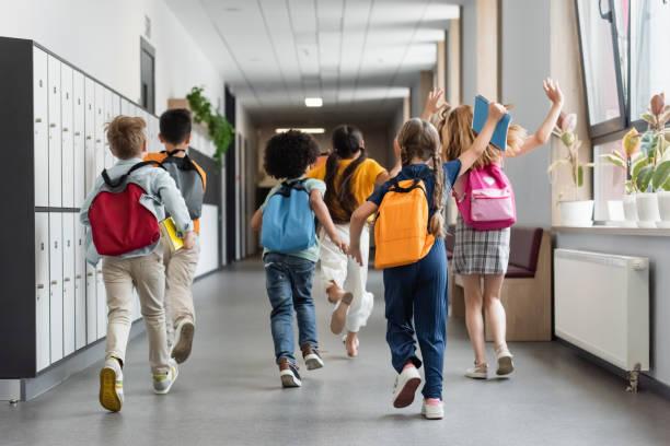istock Joyful multicultural school kids rushing back to class 2166021795