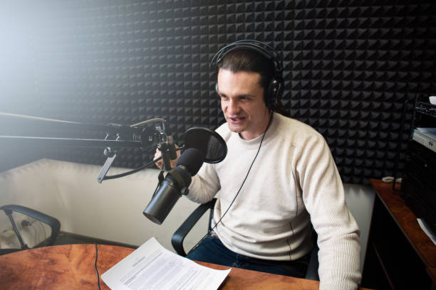 istock Podcaster recording an engaging episode in a soundproof studio, using a professional microphone and wearing headphones, ideal for podcasting, broadcasting, and audio production projects 2166021811