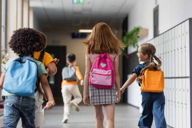 istock Multicultural kids hold hands on the way to class 2166021879