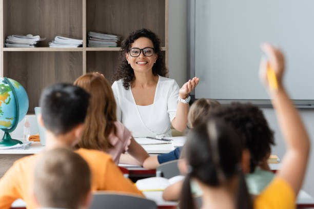 istock Happy multicultural kids learning in a vibrant classroom with their enthusiastic teacher 2166022112