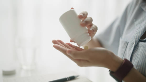 istock Teenager taking a vitamin while online learning. 2166025153