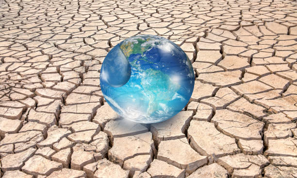 istock Glass globe inside water drop with dry soil 2166025756