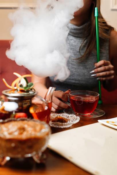 istock Woman Exhaling Smoke While Drinking Tea 2166027745