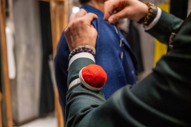 man fashion designer is working in studio horizontal close up working with hand still stock photo