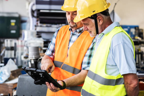 istock A supervisor stands confidently with a worker on the factory line 2166029155