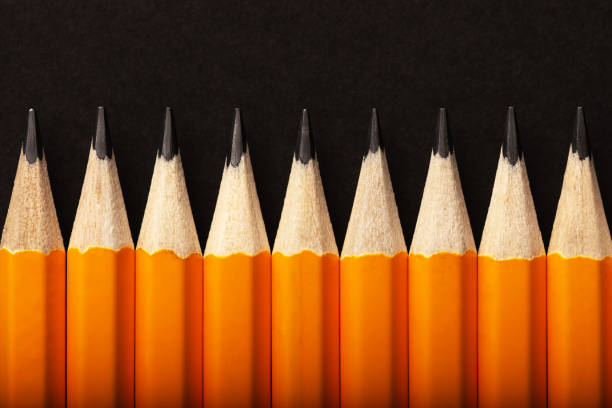 istock Abstract background of orange pencils lying in a row 2166030634
