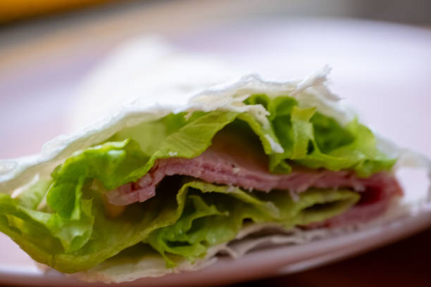 Cig kofte durum on plate. Raw meatball wrap with lettuce.