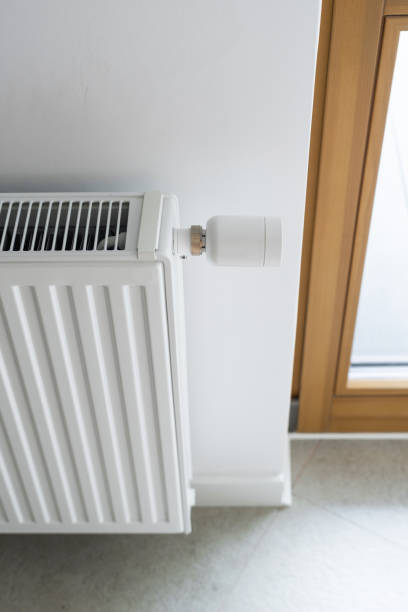istock White radiator with thermostat in modern room 2166031503
