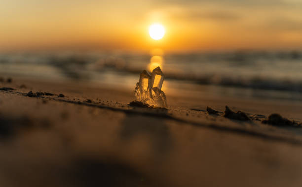 Healing crystal therapy by the sea. Crystal illuminated by the setting sun