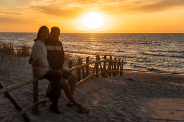 istock Romantic couple flirting on a sandy gold beach at sunset 2166031751
